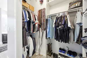 Custom closet system with multiple hanging rods, integrated shelving, and dedicated shoe storage