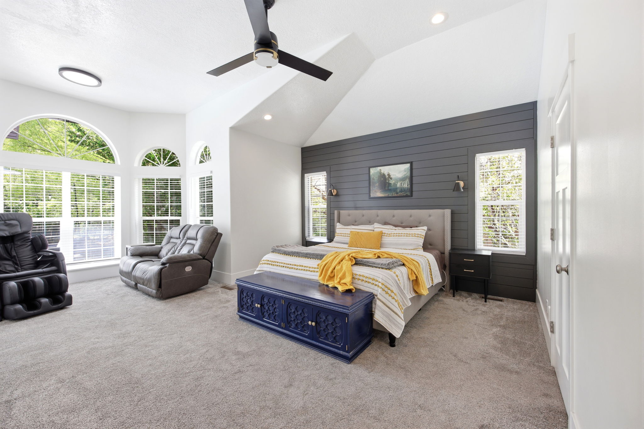 Vaulted ceiling bedroom featuring a dark shiplap accent wall, recessed lighting, and a ceiling fan