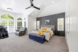 Vaulted ceiling bedroom featuring a dark shiplap accent wall, recessed lighting, and a ceiling fan