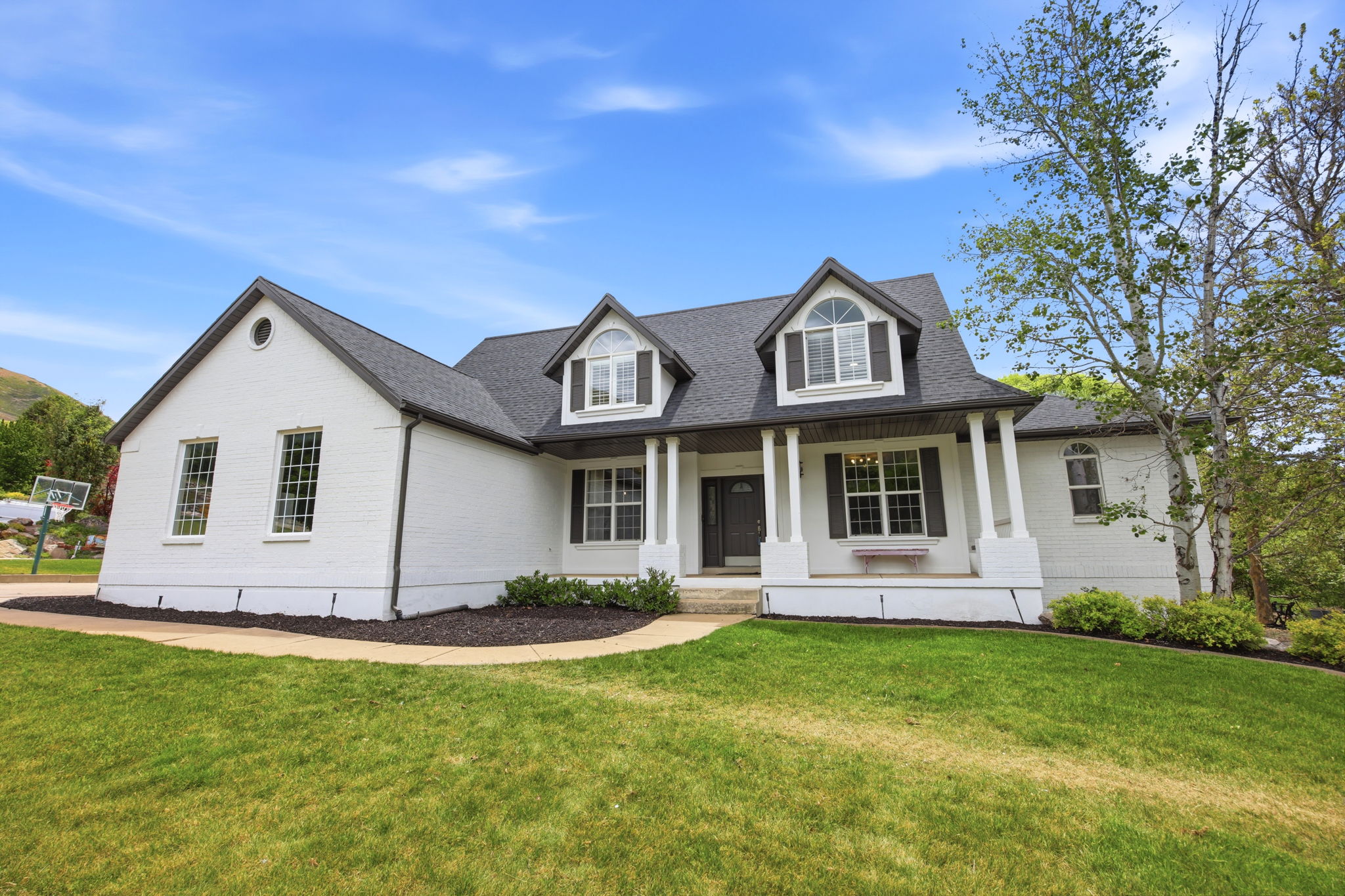 White brick exterior with a dark gray roof