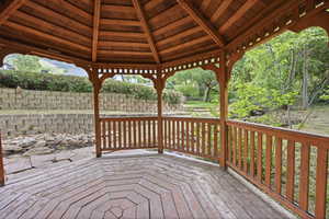 Wood gazebo featuring a multi-sided design and a slatted wood ceiling