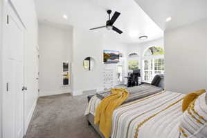 Spacious room featuring vaulted ceilings, recessed lighting, and a modern ceiling fan