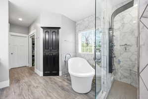 Freestanding soaking tub with floor-mounted faucet