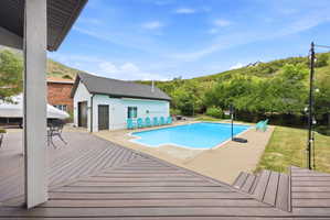 Expansive composite deck featuring a geometric pattern, offering direct access to the outdoor swimming pool