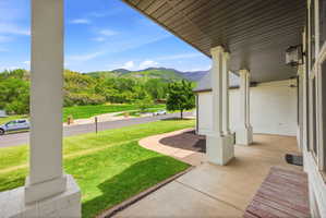 Covered porch with white brick and column accents