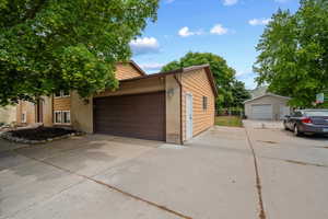 Concrete driveway providing access to a two-car garage with RV parking