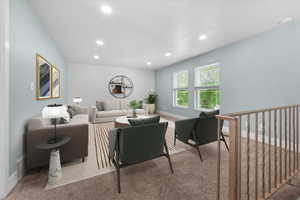 Spacious living area featuring recessed lighting and two large windows allowing natural light