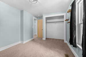 Bedroom #2 featuring light blue walls, a neutral-toned carpet, and white trim