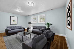 Spacious room featuring light blue walls, two windows with white blinds, and two flush-mount ceiling lights