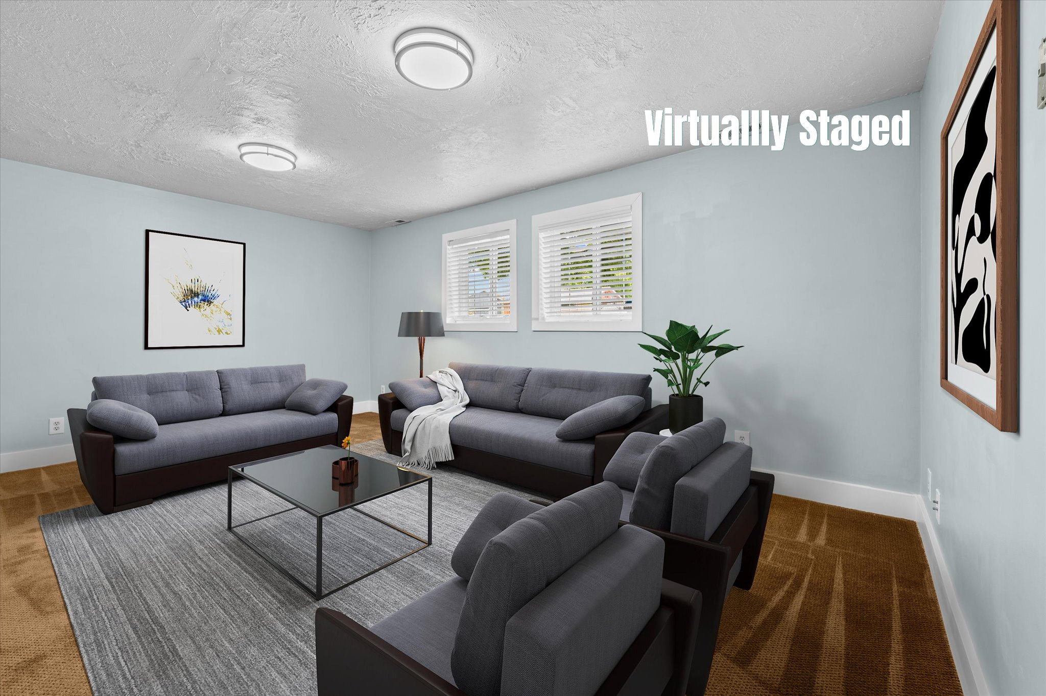 Spacious living area featuring light blue walls, two windows with white blinds, and ceiling-mounted light fixtures