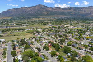 Expansive aerial perspective showcasing a residential neighborhood with distant mountain ranges
