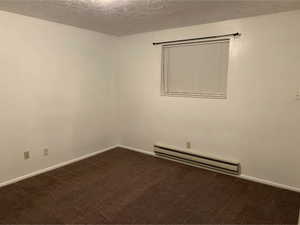Interior room featuring light-colored walls and brown carpeting