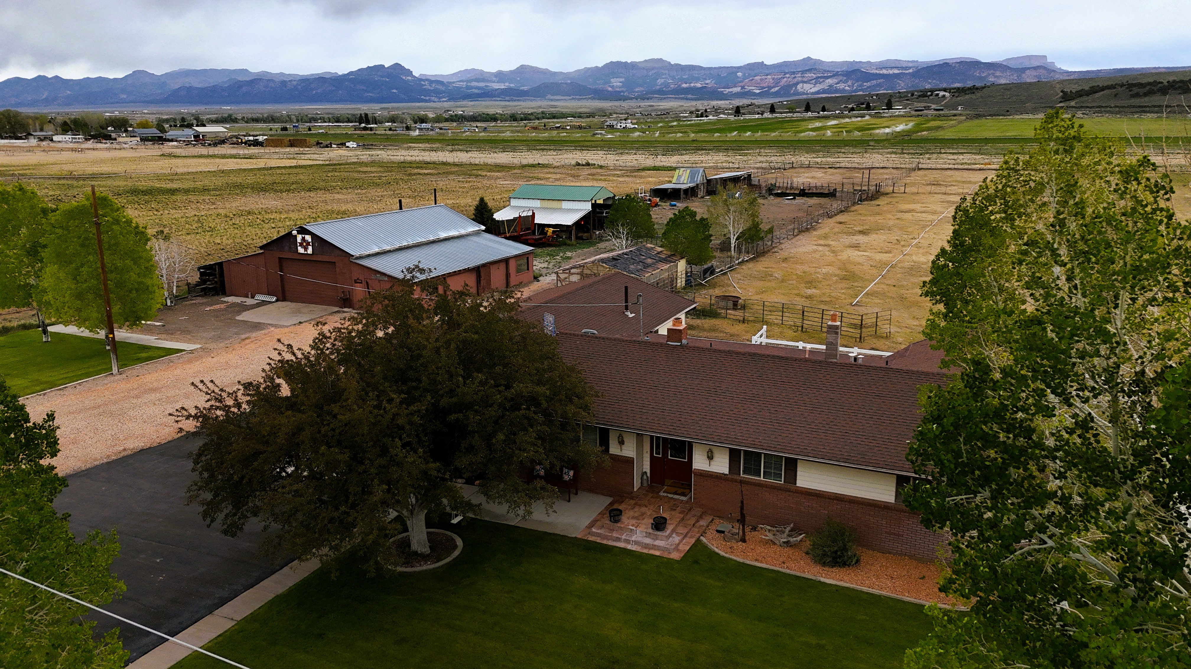 Expansive property featuring a single-story residence, a large barn with a metal roof, and additional outbuildings