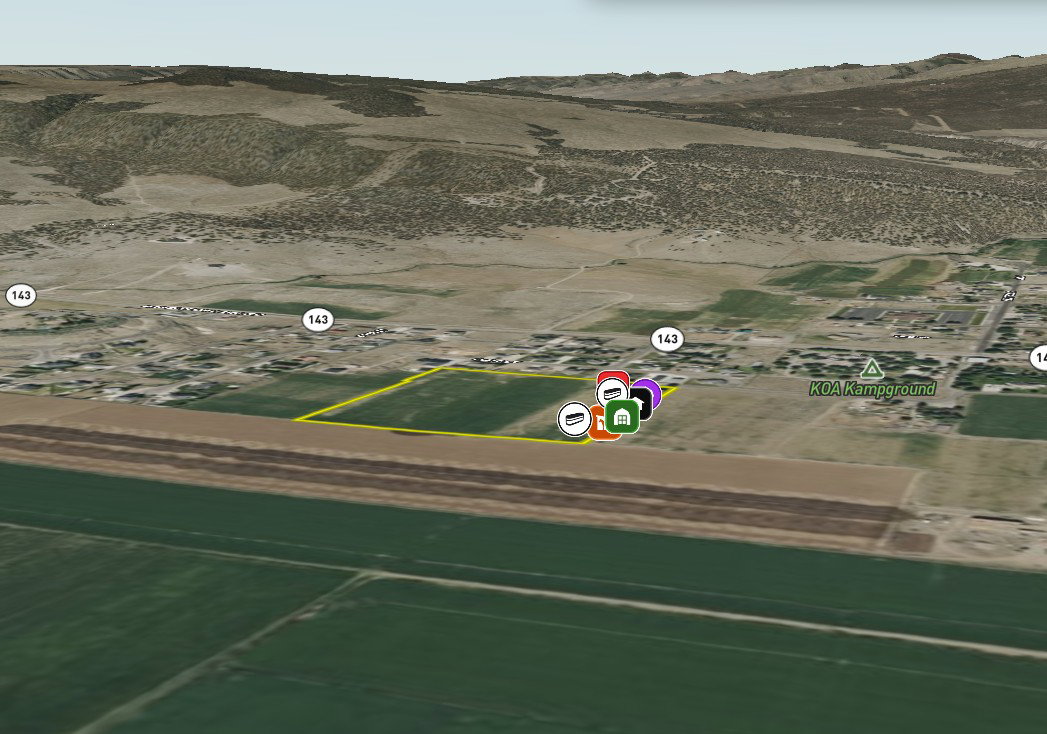 Expansive land parcel outlined in yellow, featuring visible road access (Highway 143) and proximity to a KOA Kampground