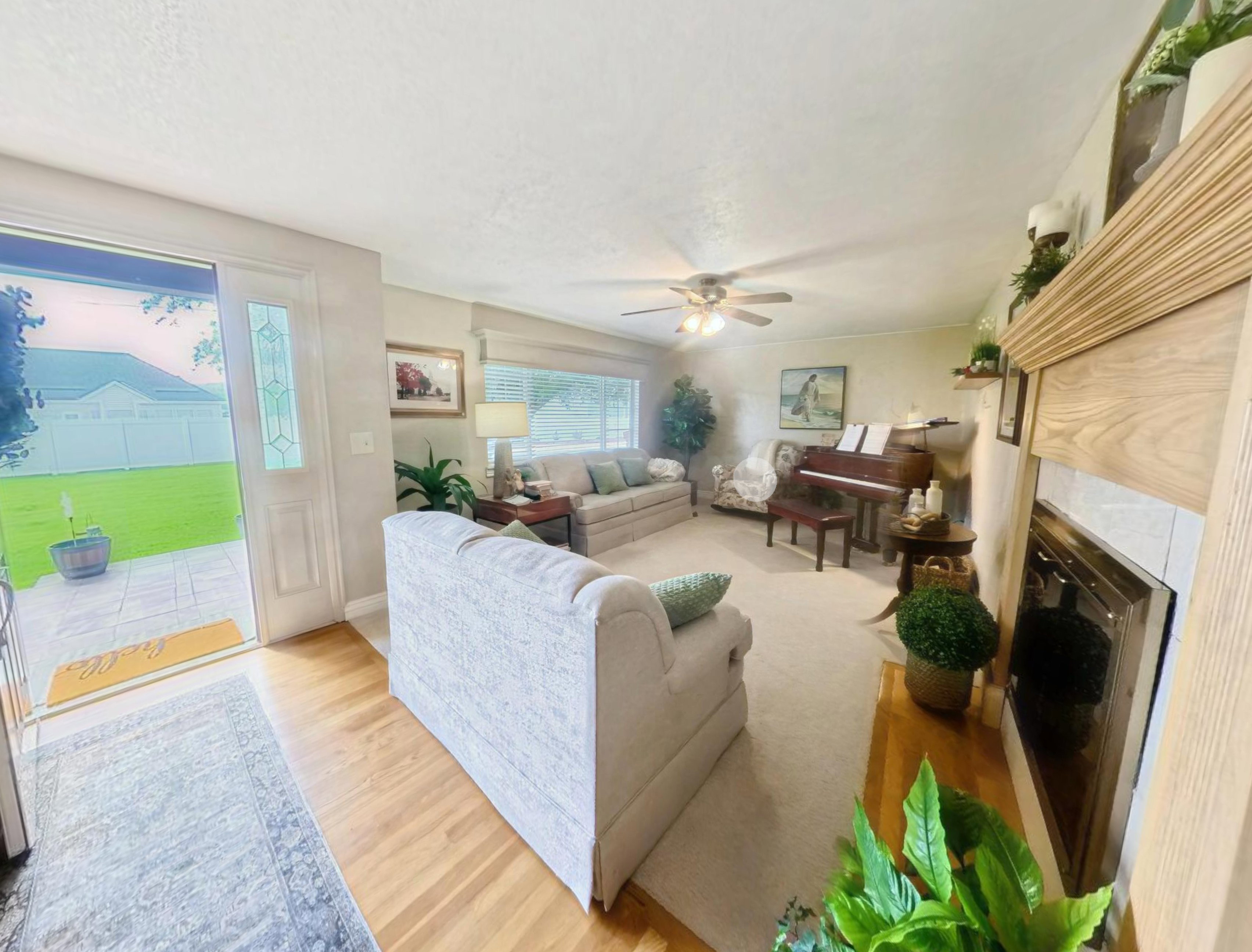 Living area featuring a fireplace with a light wood mantel and tile surround