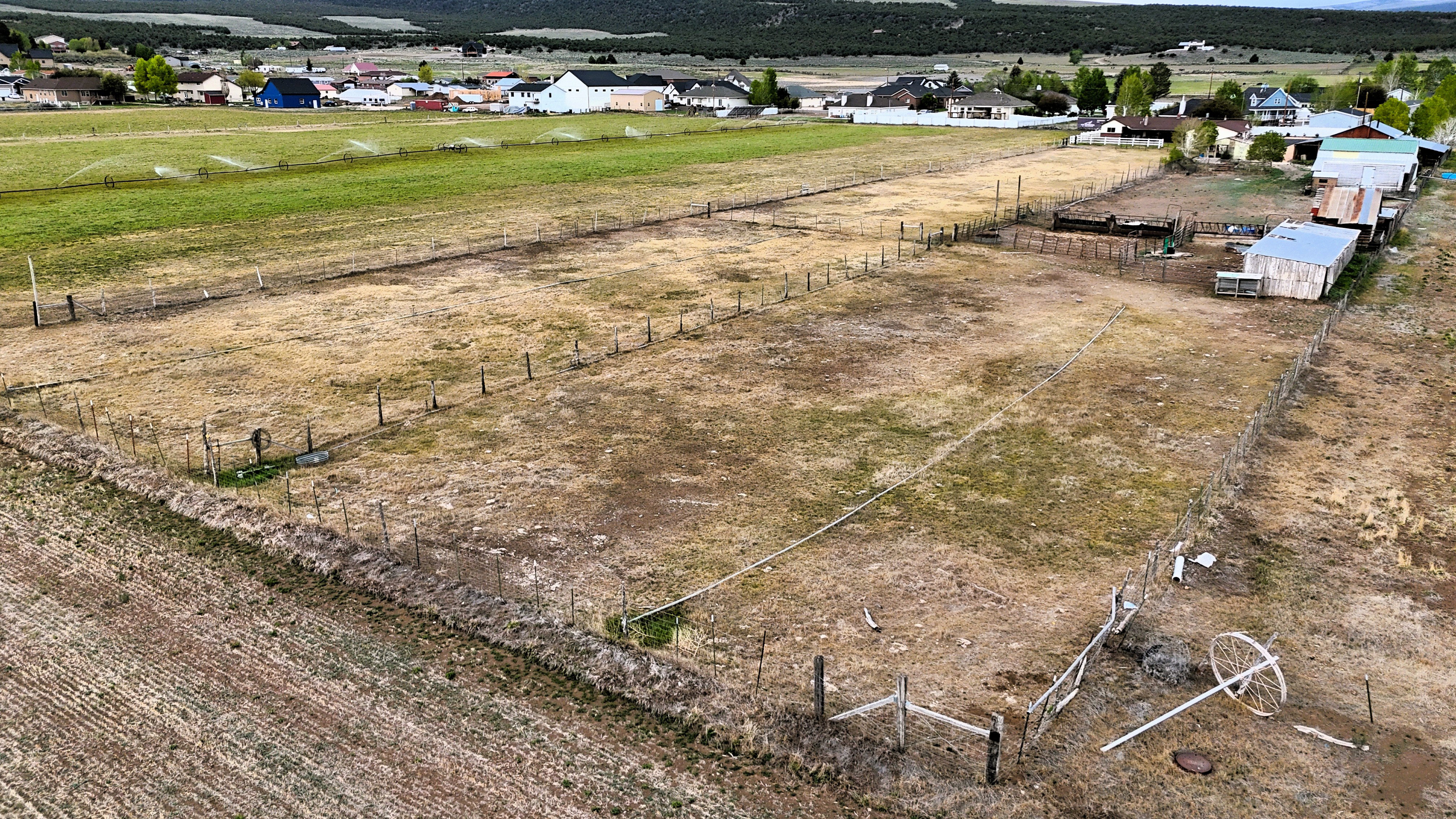 Expansive fenced parcel featuring a mix of cultivated and undeveloped land