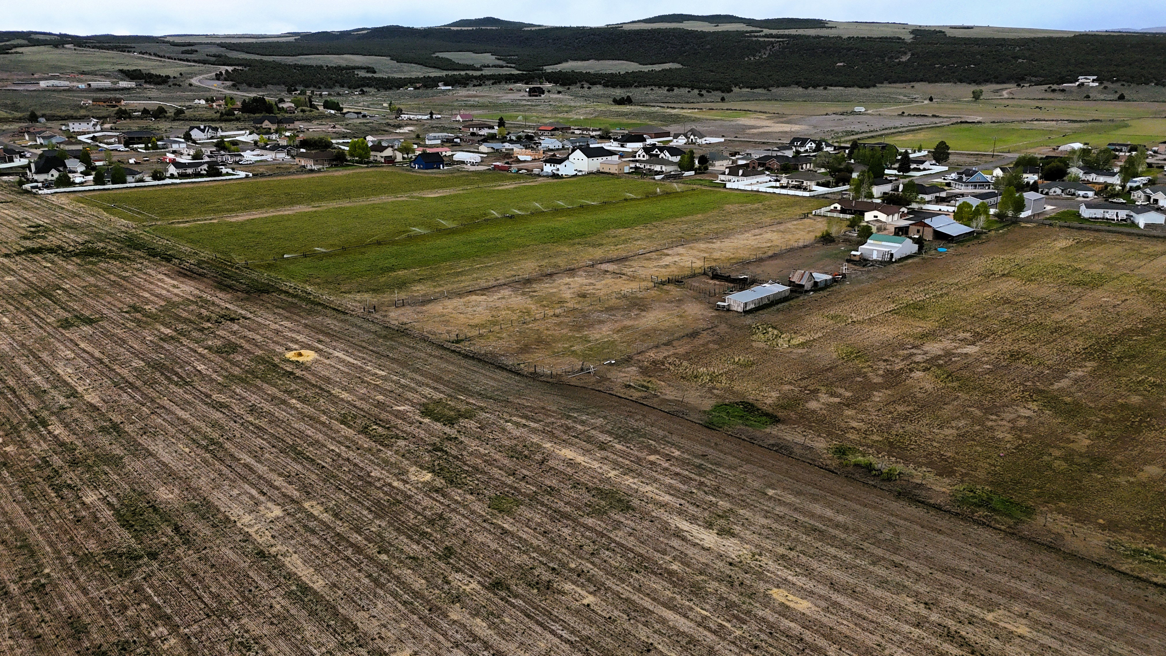Expansive agricultural land featuring cultivated fields and undeveloped parcels
