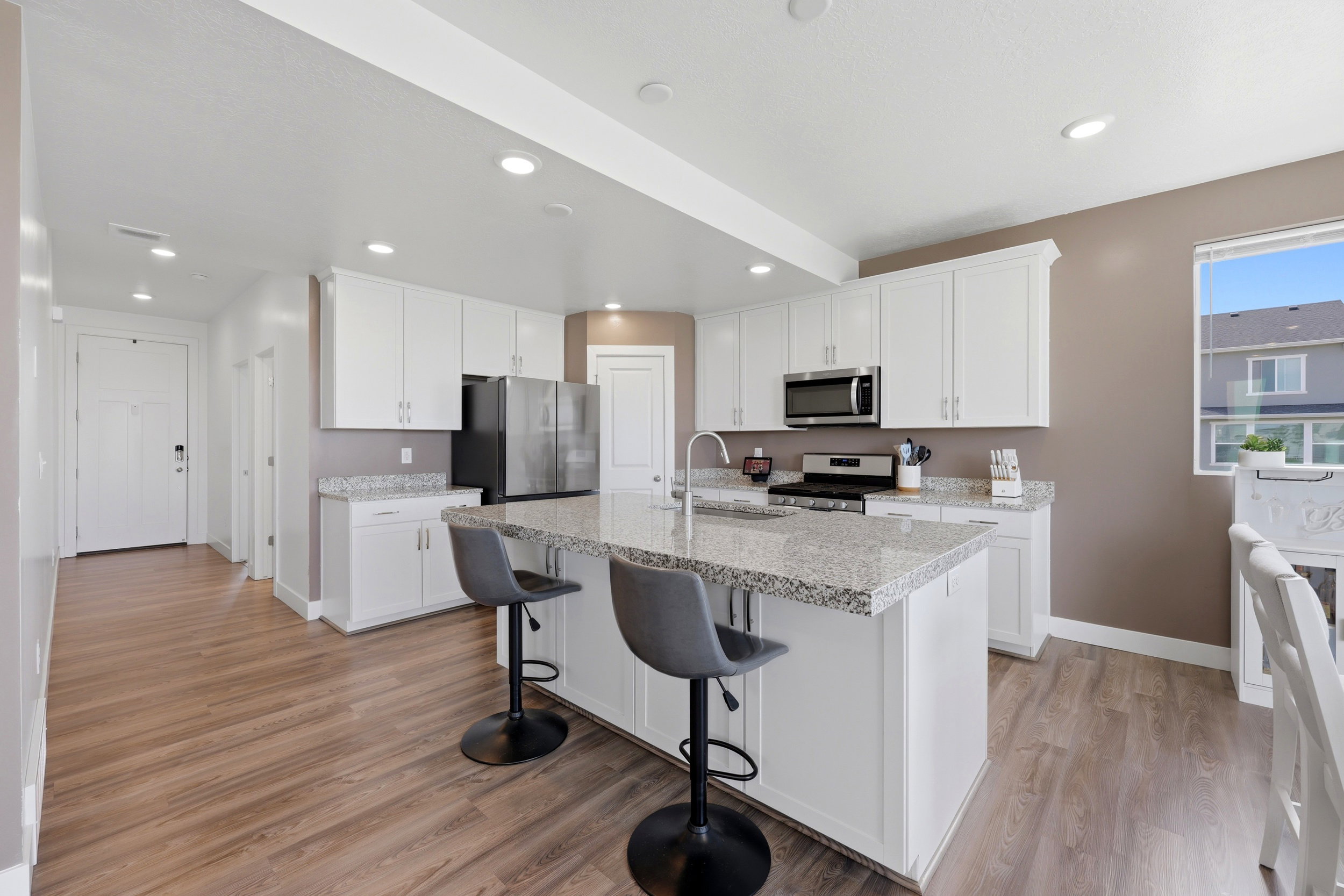 Clean white kitchen with plenty of storage.