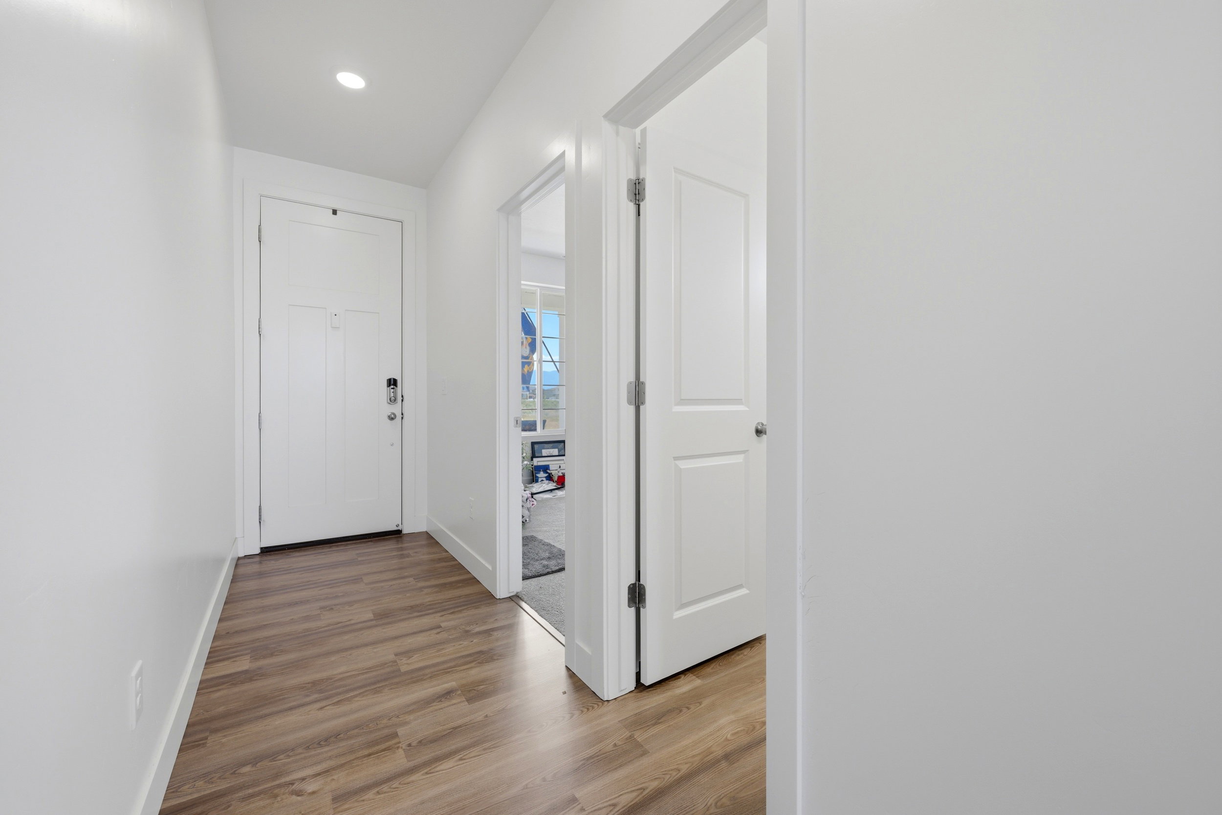 Entryway featuring wood-finish flooring and recessed lighting