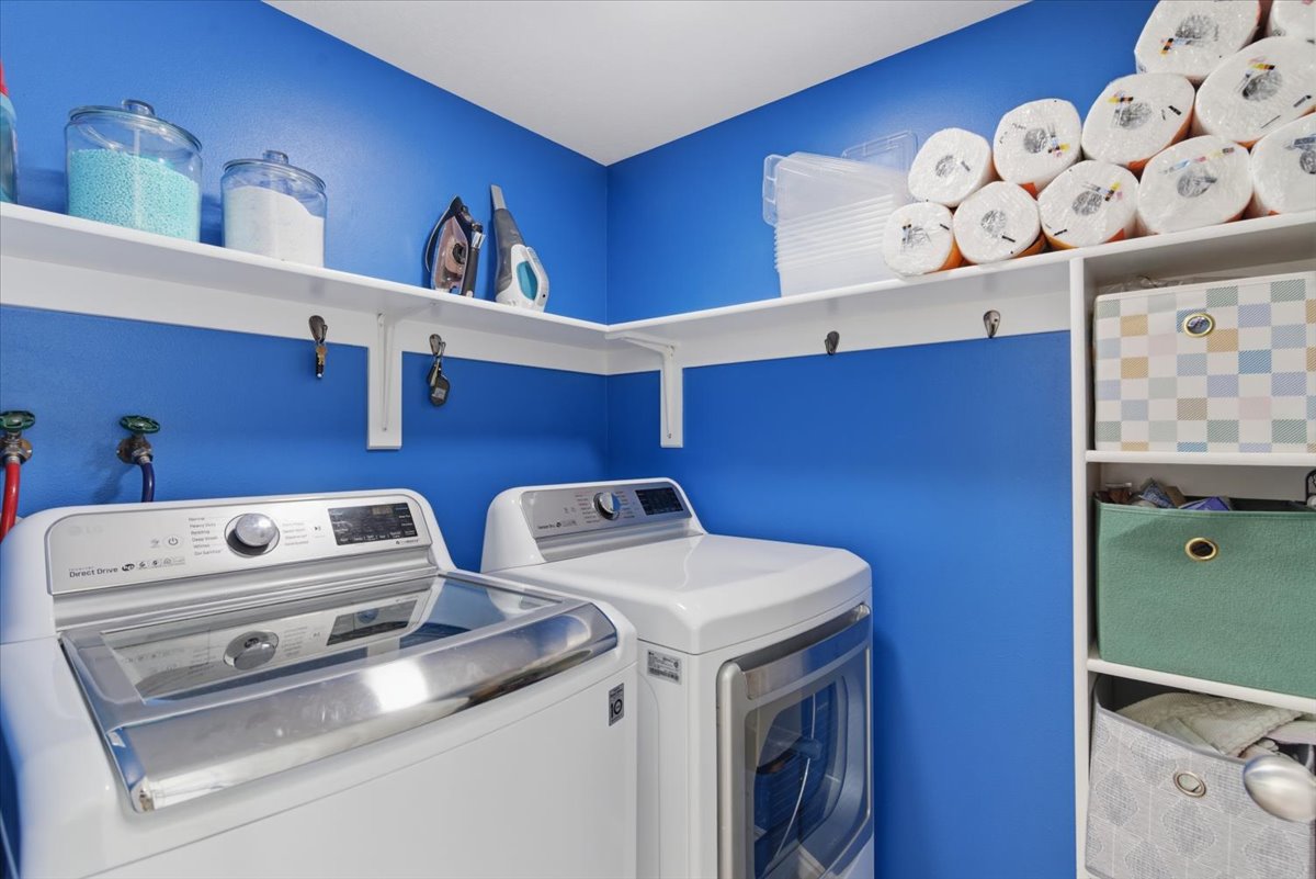 Separate laundry room with storage. Washer and dryer staying.