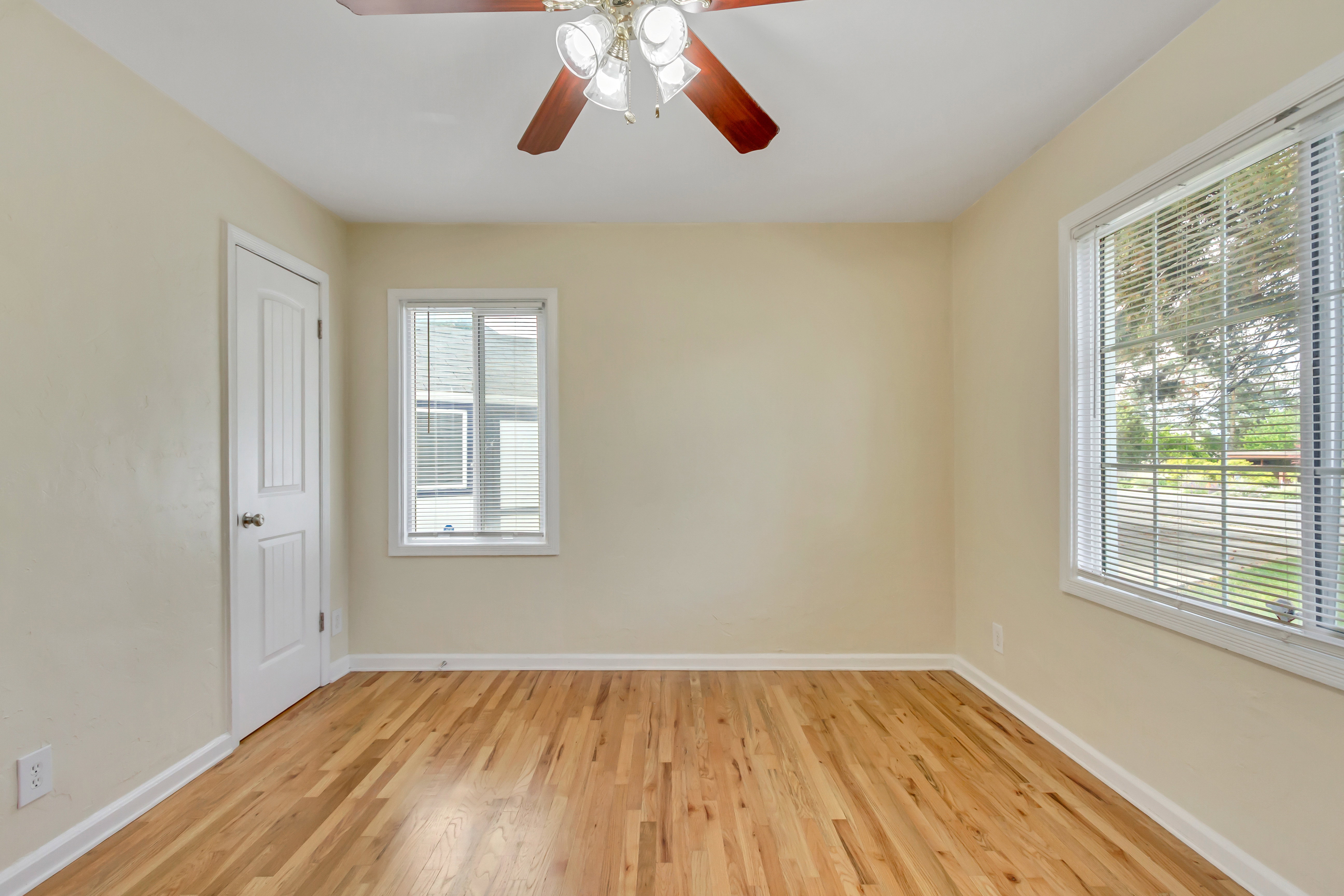 Room featuring light-toned walls and wood-finish flooring