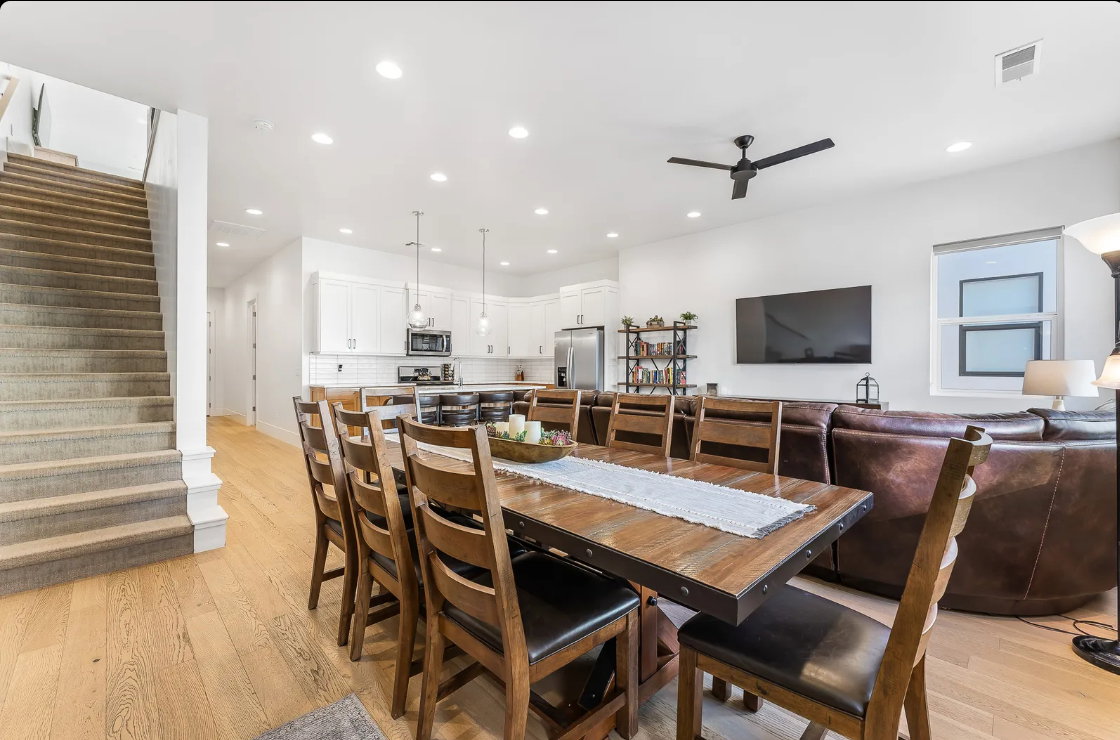 Open-concept living space with light wood-finish flooring