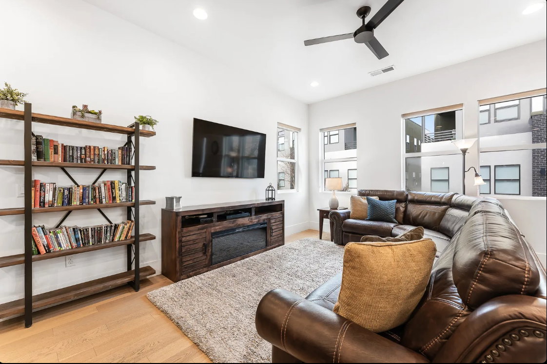 Living area featuring light wood-finish flooring and a neutral area rug
