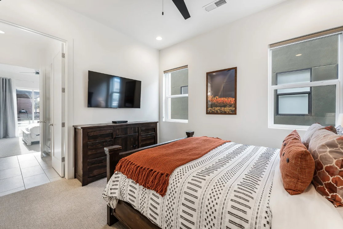 Carpeted interior space featuring a ceiling fan, recessed lighting, and white walls