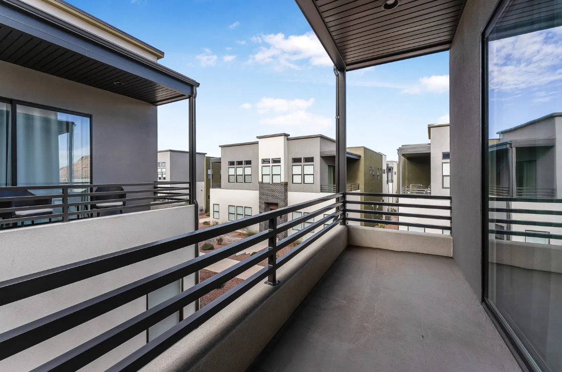 Private balcony featuring contemporary black metal railings and a concrete surface