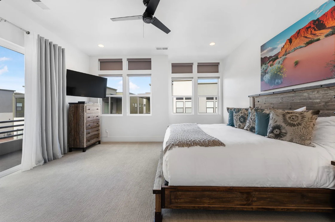 Bedroom featuring light-toned carpet flooring, a ceiling fan with integrated lighting, and recessed ceiling lights