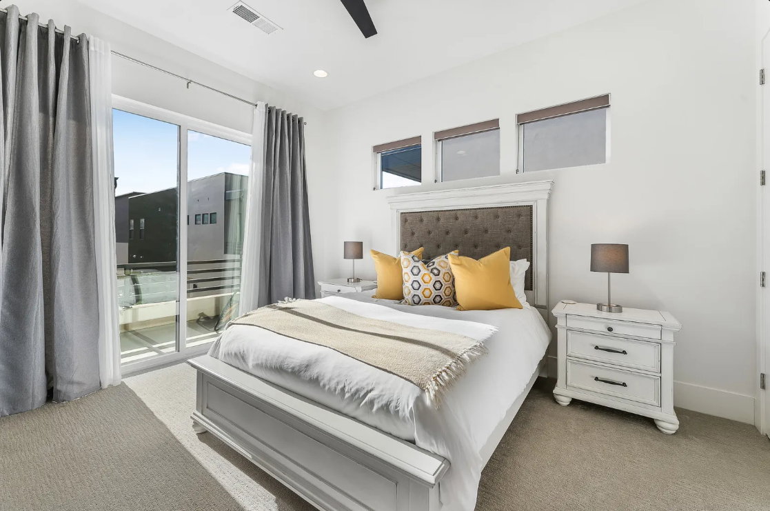 Sliding glass doors open to a private balcony
