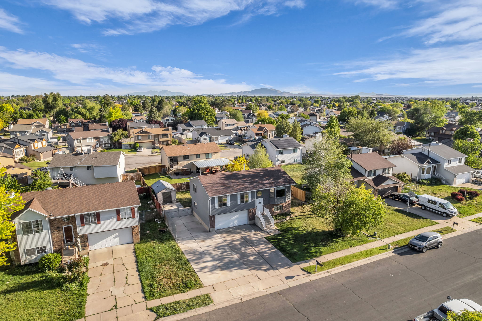 Established neighborhood setting with mature trees and mountain backdrop