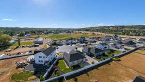 Aerial perspective showcasing a residential development with multiple single-family homes, each featuring dark-shingle roofing and light-toned siding