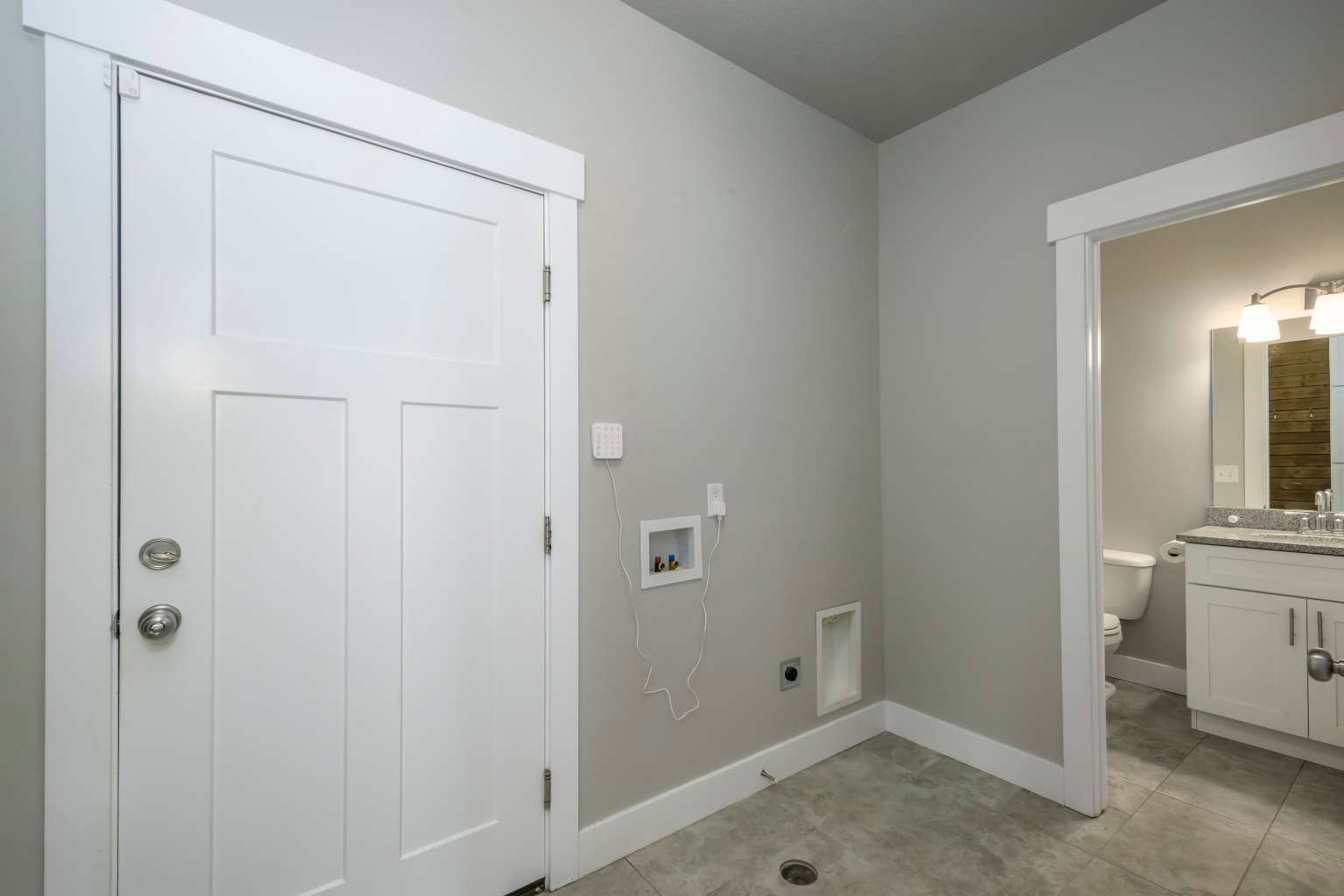 Utility space with gray wall paint and tile flooring