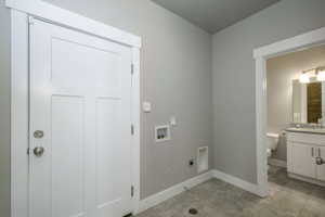 Utility space with gray wall paint and tile flooring