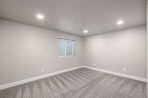 Neutral tone walls with white trim and recessed lighting