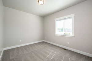 Neutral-toned walls complement the gray patterned carpeting