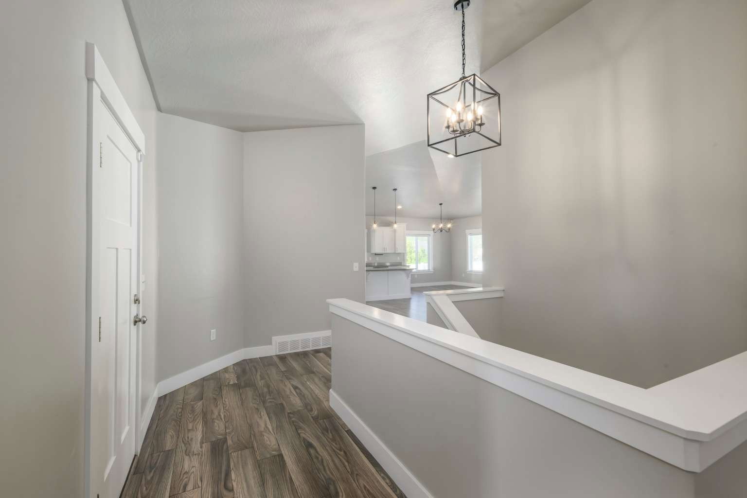 Entryway featuring wood-finish flooring and a contemporary geometric chandelier