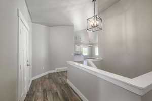 Entryway featuring wood-finish flooring and a contemporary geometric chandelier