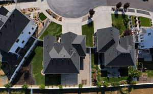 Aerial perspective showcasing the property's roofline, surrounding landscaping, and neighborhood street design