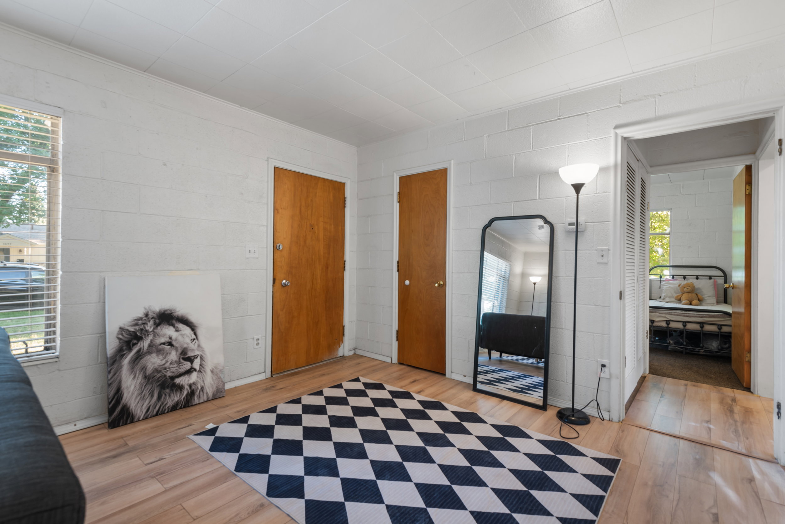 Light wood-finish flooring complements the white painted block walls