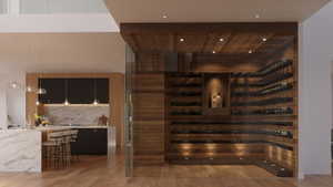 Custom wine cellar with wood-finish paneling, glass enclosure, and recessed lighting