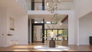 Grand foyer with double-height ceilings, a built-in elevator, and glass railing balcony