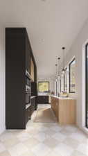 Modern kitchen featuring contrasting black and light wood cabinetry, integrated stainless steel appliances, a stone-finish backsplash, and pendant lighting
