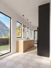 Gallery space featuring large format windows, recessed lighting, and a long built-in cabinet with a light-toned countertop and wood-finish cabinetry