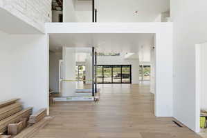 Expansive open-concept interior featuring light wood-finish flooring throughout