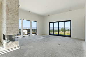 Stone-clad fireplace with a three-sided glass enclosure