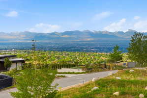 Panoramic mountain and city landscape with a modern-style residence featuring a flat roofline