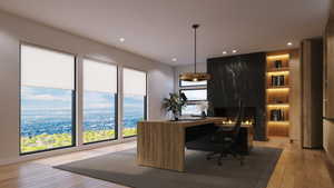 Spacious room featuring floor-to-ceiling windows, recessed lighting, and wood-finish flooring
