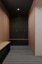 Built-in black cabinetry with metal hardware, wood-finish wall panels, recessed ceiling lighting, and striped carpeting